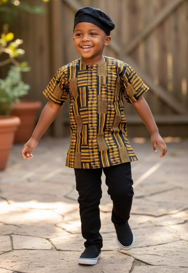 Child wearing a patterned Kente dashiki shirt and black pants outdoors