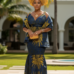 Woman in a blue and yellow traditional African print Ankara outfit standing outdoors with palm trees in the background by Dupsie's African fashion