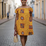 Woman in a yellow patterned dress standing on a street