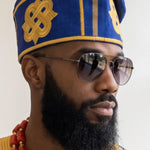 African Aso Oke hat for men featuring royal blue woven fabric with gold embroidery for Nigerian traditional fashion.