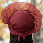 Elegant African fashion featuring a pre-tied Aso Oke head wrap in vibrant burgundy.