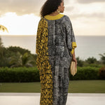 Back view of Black Gray and yellow African clothing kaftan dress for women showing loose fit and flowing African dress silhouette.