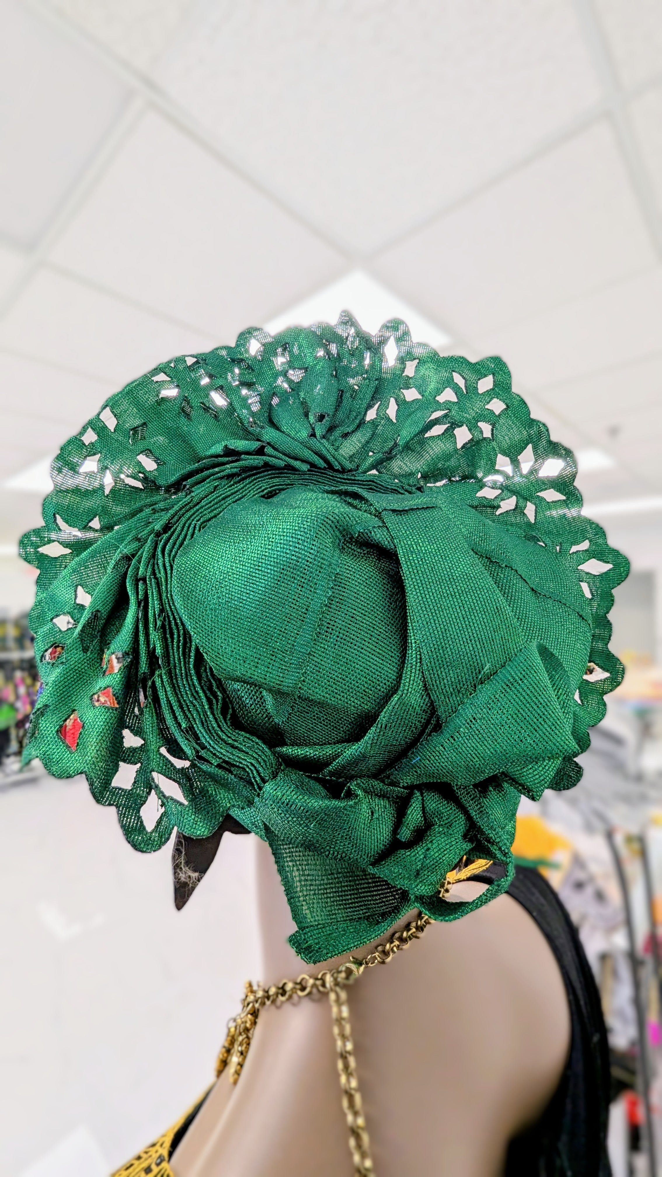 Pre‑tied Nigerian gele in emerald green with laser‑cut fan and glitter
