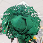 Pre‑tied Nigerian gele in emerald green with laser‑cut fan and glitter