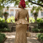 Detail view of the fitted short-sleeve peplum top with a zipper and traditional hook closure on the flare skirt, highlighting African fashion elegance