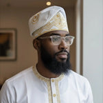 Elegant African hat for men in white and gold Aso Oke fabric styled as a Yoruba fila with jean-like texture, perfect African clothing for men.