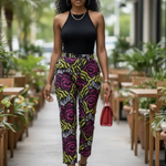 A woman demonstrating stylishly worn Alina African print pants outdoors.