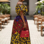 Elegant African print skirt suit for women featuring yellow purple Kitenge crop top and matching high waist cotton maxi skirt.