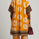 African tie-dye kimono top and pants for women in orange and off-white African print