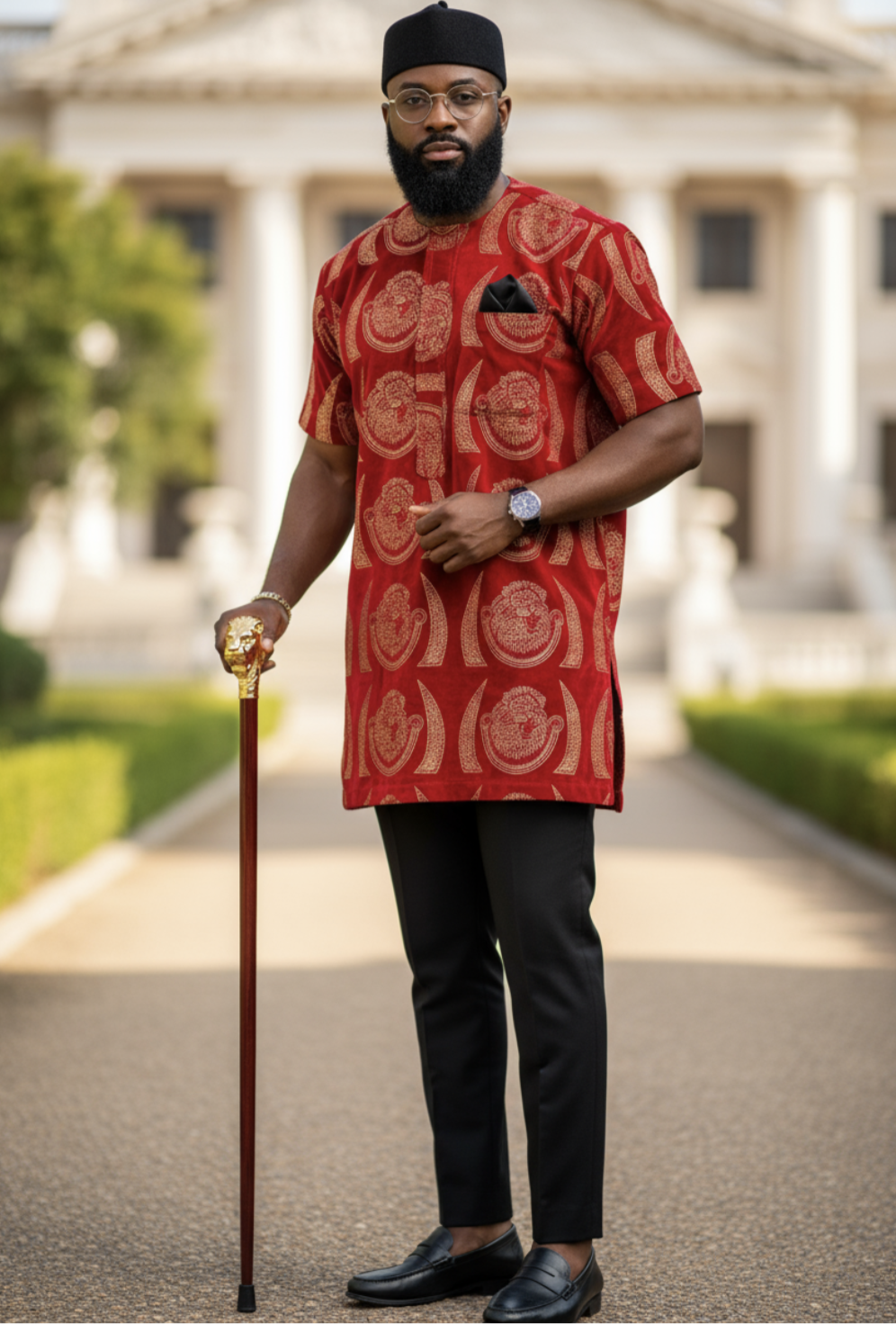 Stylish African Velvet Isiagu shirt, showcasing vibrant red and gold patterns with a pocket square and black loafers