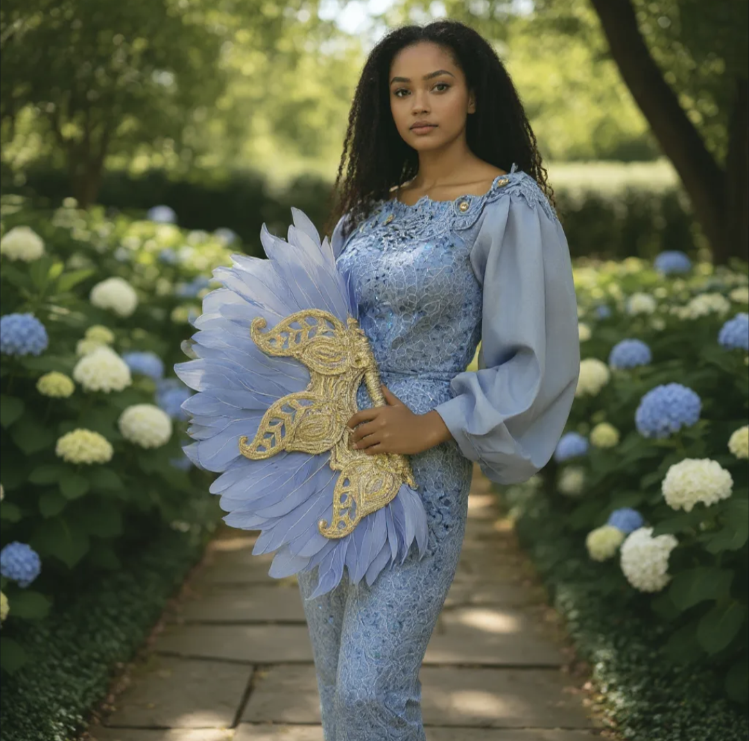 Light-blue African bridal feather fan with ornate silver handle and glitter stones by Dupsie’s African Fashion