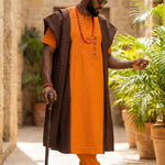 Nigerian groom wearing a Dipo Aso Oke Agbada robe at a wedding.