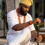 Cream and gold Nigerian Yoruba African Aso Oke Fila cap hat for men worn with traditional African clothing and African fashion.