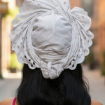 White lazercut ready gele African fashion for women with rhinestones and fan‑style crown by Dupsie’s African clothing brand