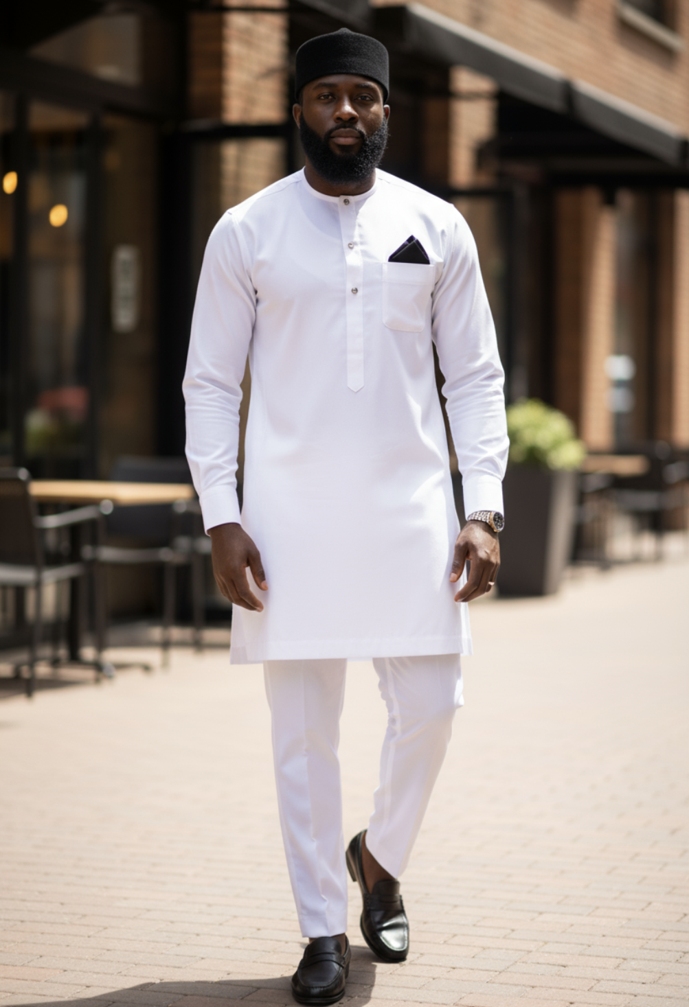 All-white slim-fit African Senator dashiki by Dupsie’s with vertical pocket embroidery, 3-button neckline, French cuffs, and matching drawstring pants.