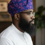 Side profile of Bayo handwoven Damask Aso Oke Yoruba fila African hat for men styled with elegant African fashion attire