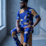Faruq men's African print Dashiki set with short sleeve shirt and matching pants in blue, beige, black and cream geometric print.