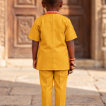 Full-length_view_of_the_gold_Nigerian-inspired_Senator_outfit_for_boys_3_attah-gold-african-kaftan-shirt-detail-boys.webp_Close-up_of_t