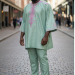 Green dashiki top with pink embroidered panels and matching pants from Dupsie's African Fashion, showcasing traditional brocade motifs with a modern silhouette