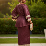 Woman wearing Efee ensemble at an African wedding, exuding elegance