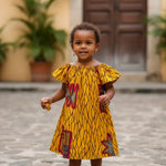Jere dress in golden yellow with African print for girls.