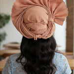 Model wearing the Jibike head wrap at a wedding, displaying its versatility.