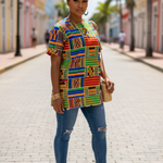 Woman wearing the Lema Dashiki top with vibrant colors symbolizing African heritage