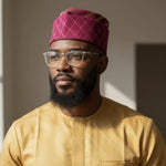 Nigerian Aso Oke fila hat in fuchsia and gold patterns styled for African men fashion and African weddings by Dupsie’s African Fashion