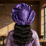 Nigerian pre-tied head wrap hat in rich purple gele by Dupsie’s African Fashion styled with elegant African fashion for women.