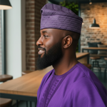 Nigerian wedding hat for men in purple Aso Oke African fabric styled as African attire for African weddings.