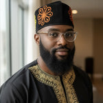 Nigerian wedding hat for men featuring Ranti velvet fila with golden yellow floral embroidery and orange trim, stylish African attire for African weddings