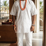 Premium Nigerian Groom African Agbada featuring embroidered white lace robe, matching Buba Sokoto set and luxury African fashion styling.