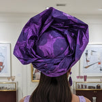 Elegant purple African head wrap for women, suitable for weddings and celebrations.