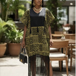 Lemon green and yellow African print dress with black fringes displayed on a mannequin.