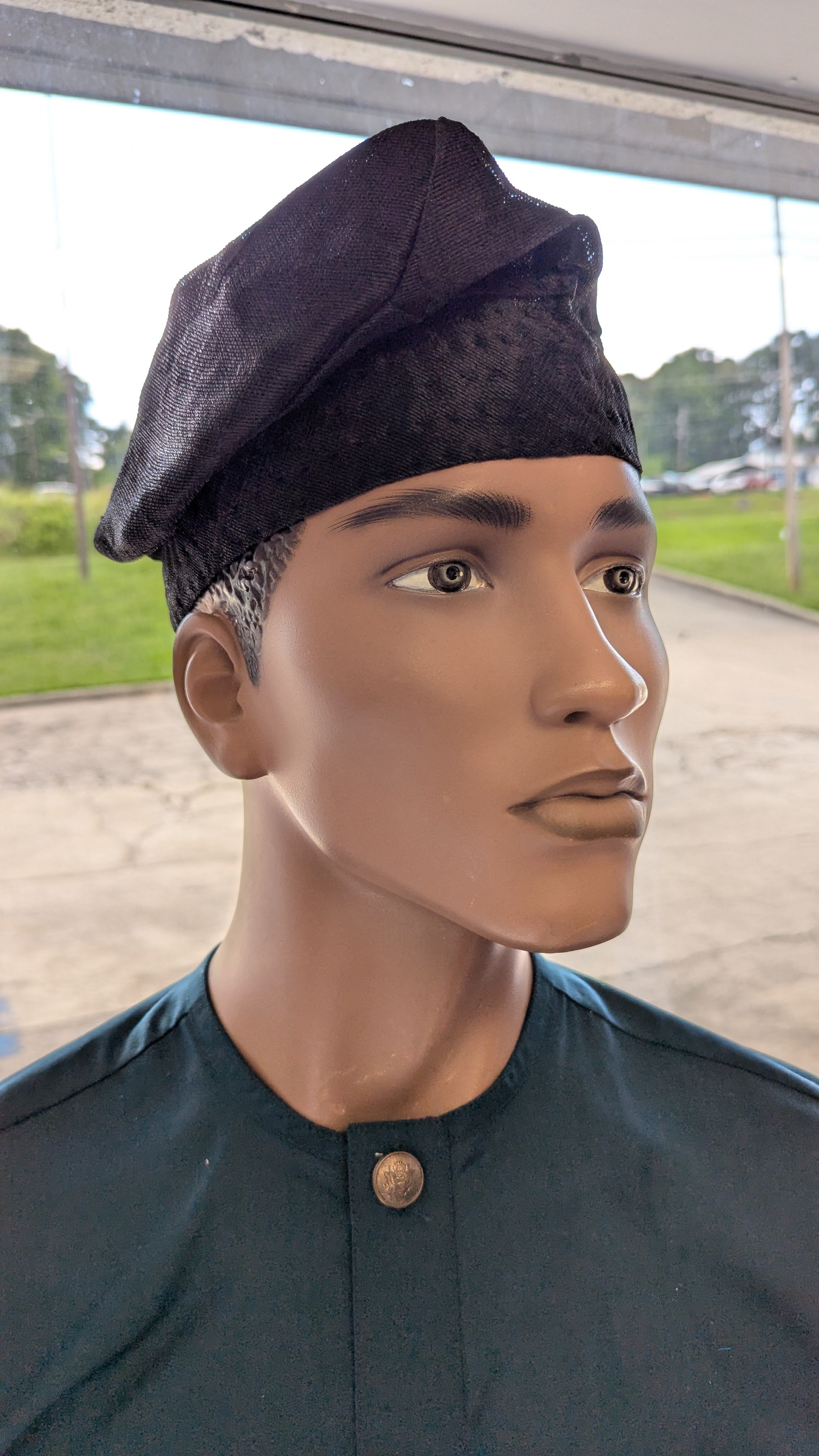 Close-up side view of all-black handwoven Aso Oke kufi hat – luxury African clothing accessory"