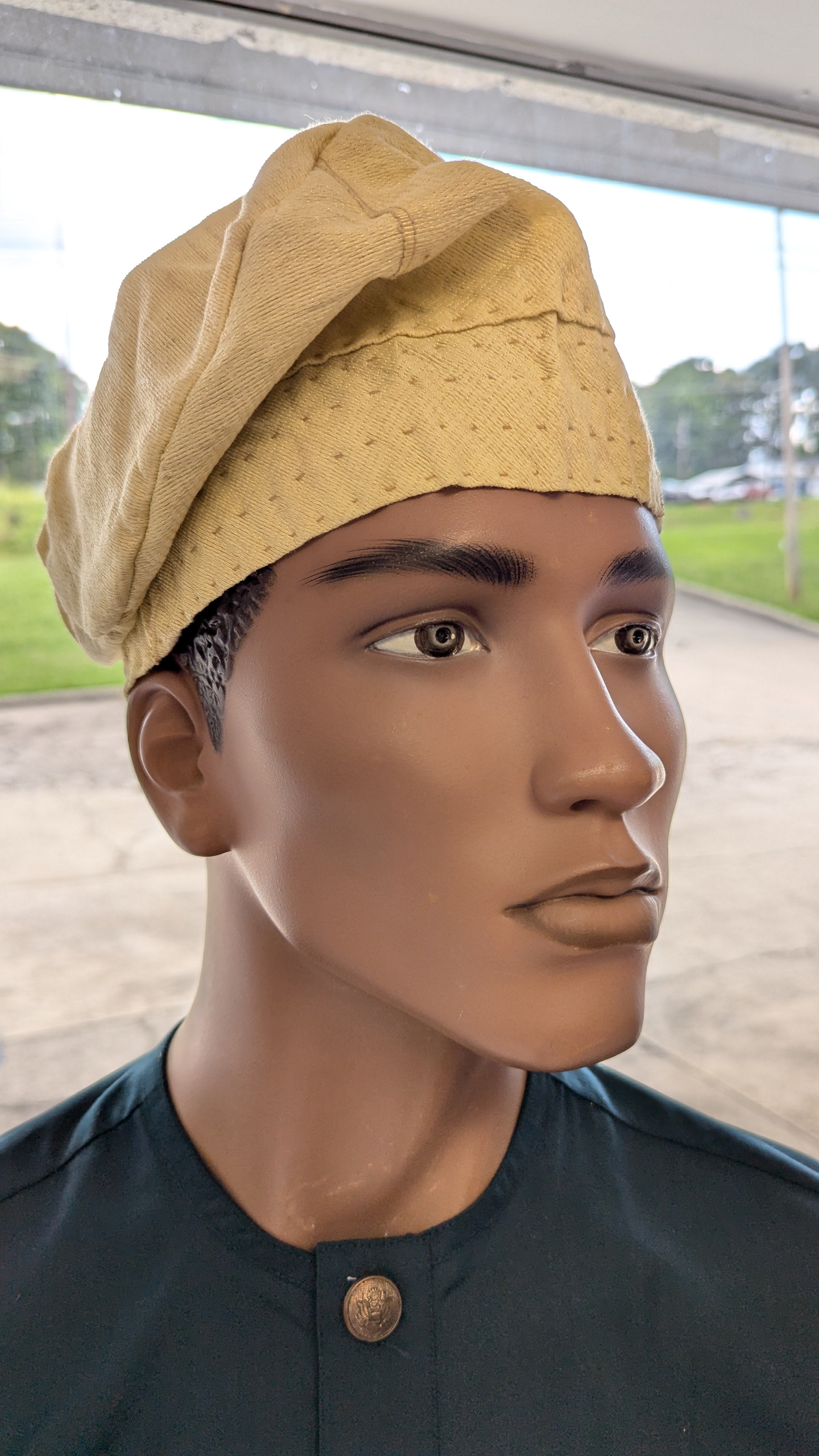 Side view of cream Aso Oke brimless kufi cap – African clothing hat symbolizing purity and dignity in Yoruba fashion.
