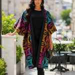 Detailed view of rhinestone embellishments on the Sandrah African print kimono dress.