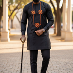 Taloju African Senator Suit showcasing the Black Dashiki top with Orange and Green embroidery.