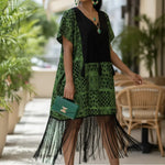 Close-up of Tessa dress showing intricate black fringe details.