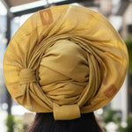 Close-up of the Tolani pre-tied Aso Oke hat’s texture and fabric pattern.
