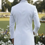 White African bishop collar suit with rhinestones and slim-fit pants for Nigerian groom fashion and African weddings.