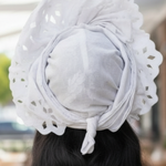 Side view of Wonu African Autogele Nigerian wedding hat for women with bow detail, showcasing African fashion and African attire elegance